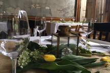A small Potager table detail with greenery and a yellow flower