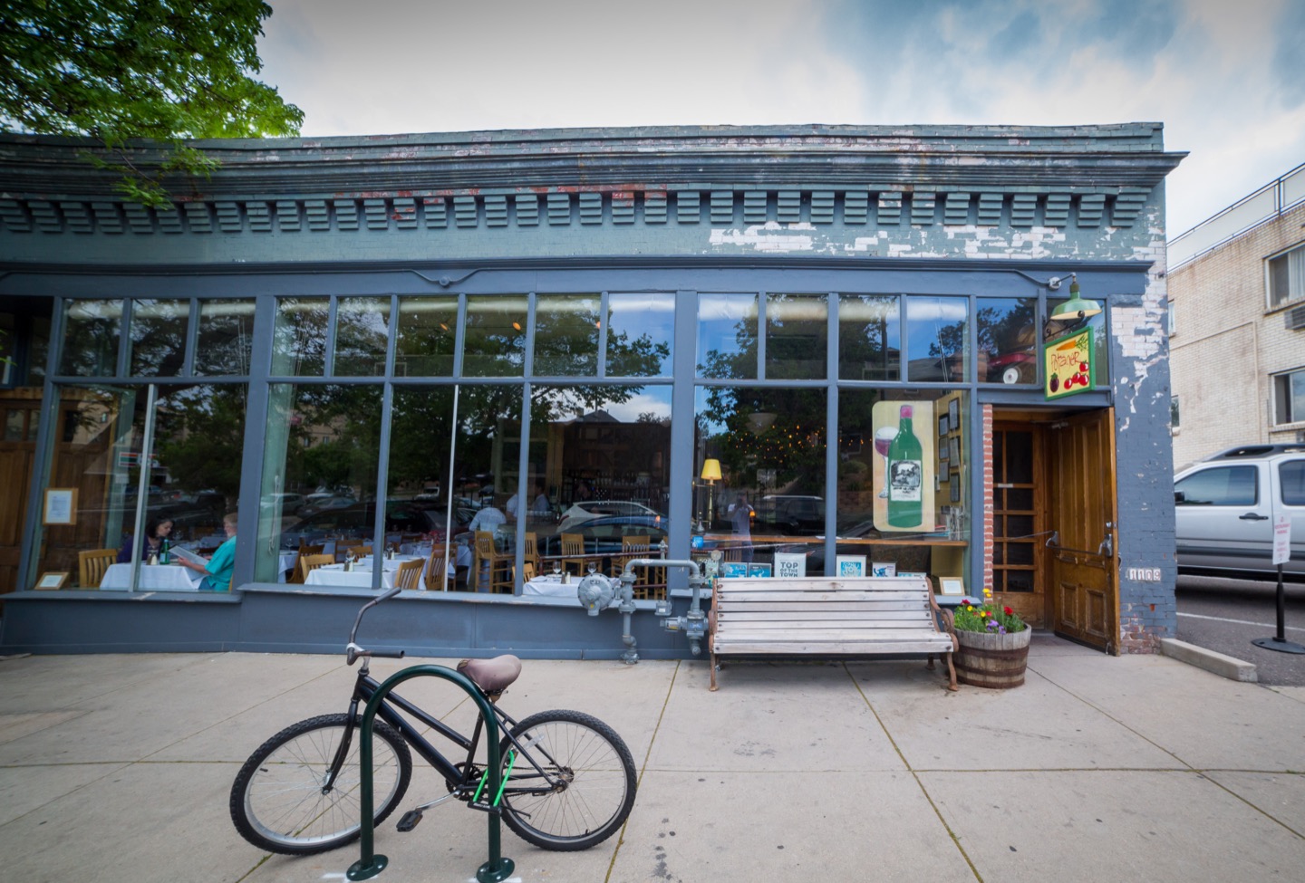 Potager’s Ogden Street storefront with a bicycle outside and the dining room visible through the windows